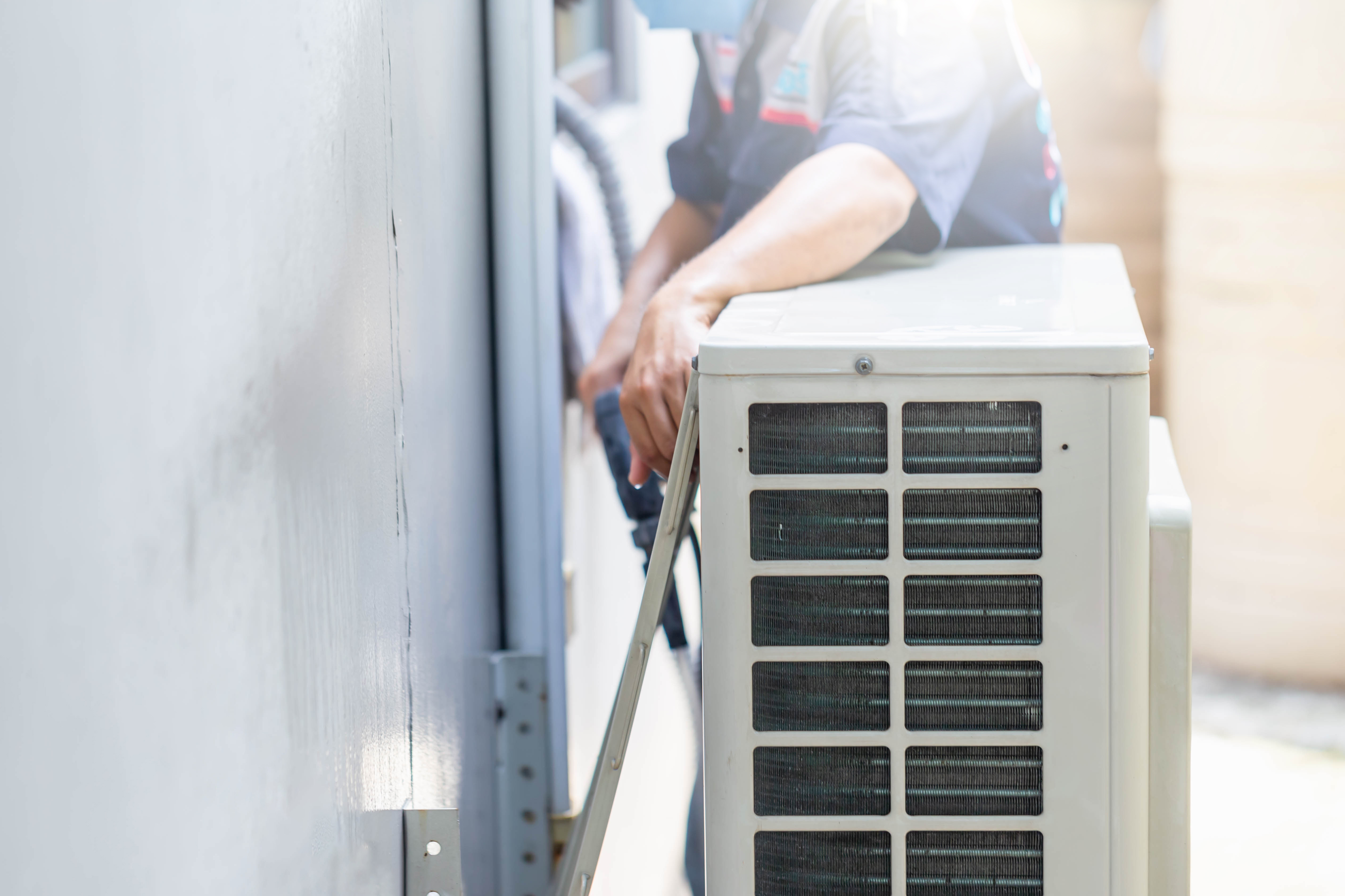 An HVAC technician providing careful heating replacement in Eagle Mountain, UT.